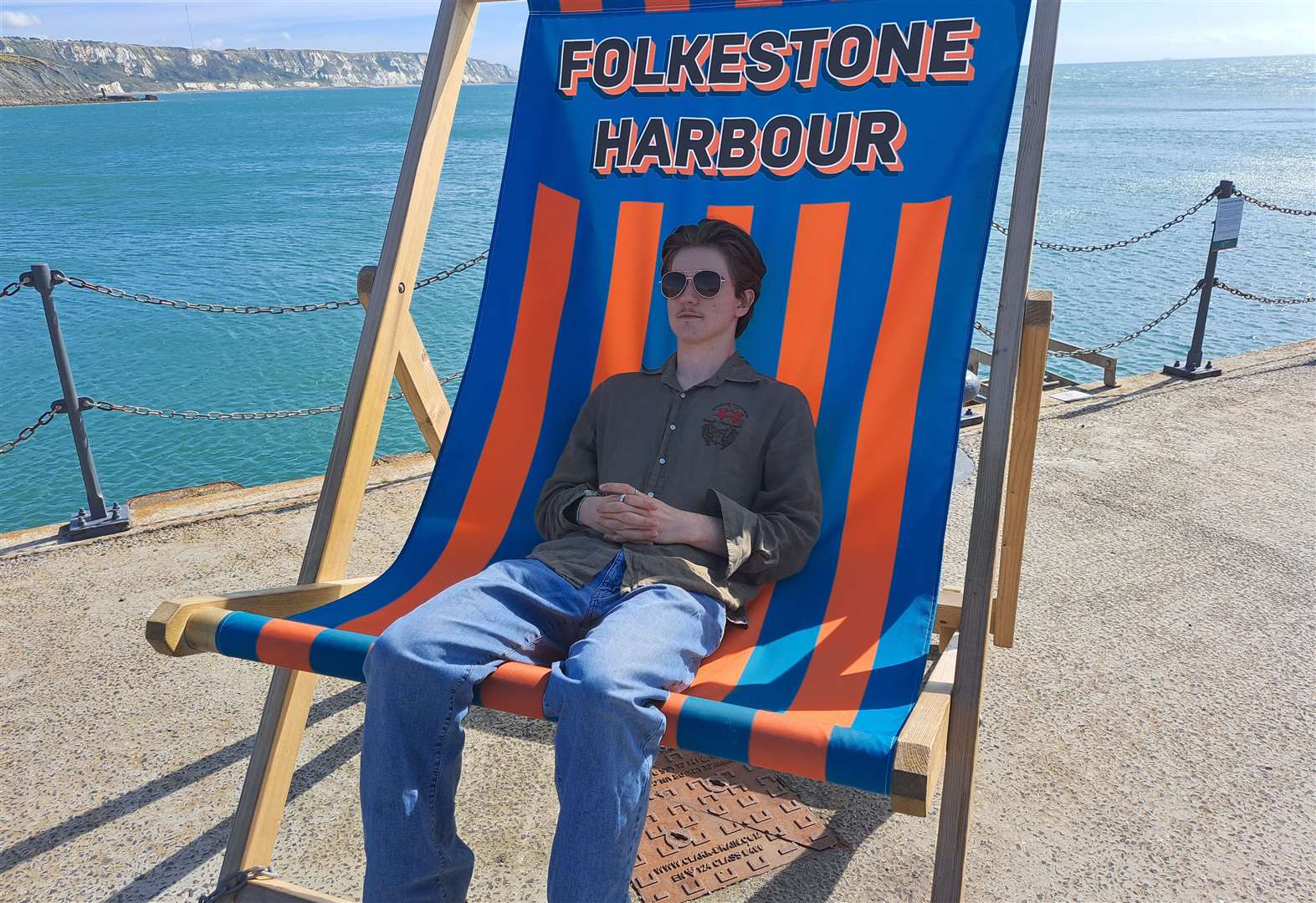 Jonny Flood, visiting from Dartford, tries out Folkestone harbour arm’s giant deckchair