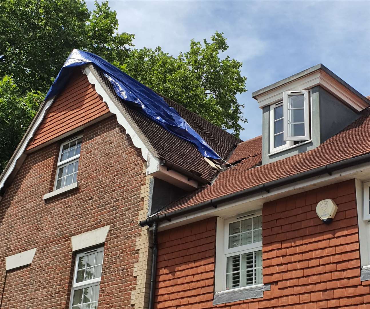 Tarpaulin has been put across the exposed loft.