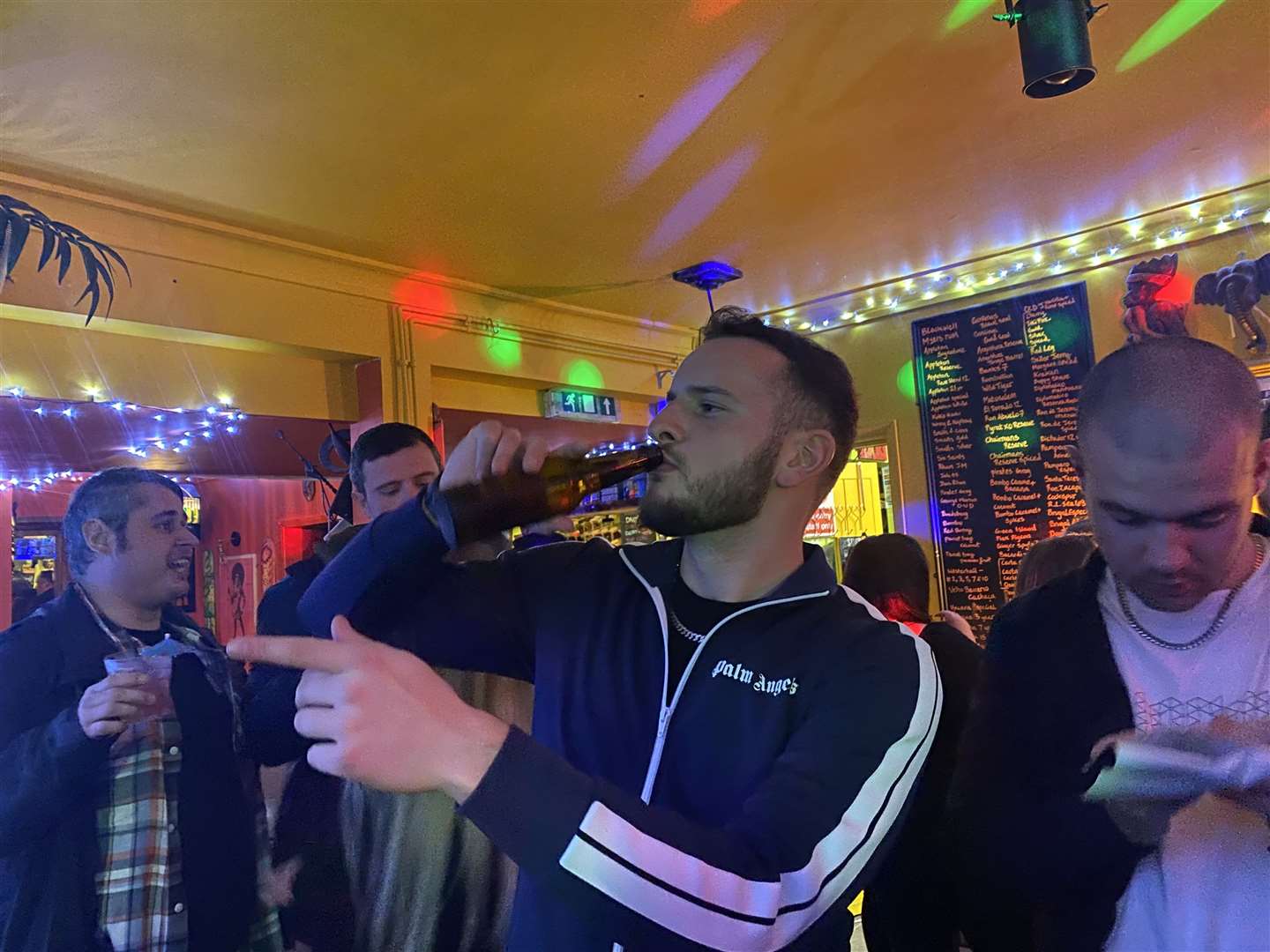 A party-goer enjoys a beer at The Rum Clinic