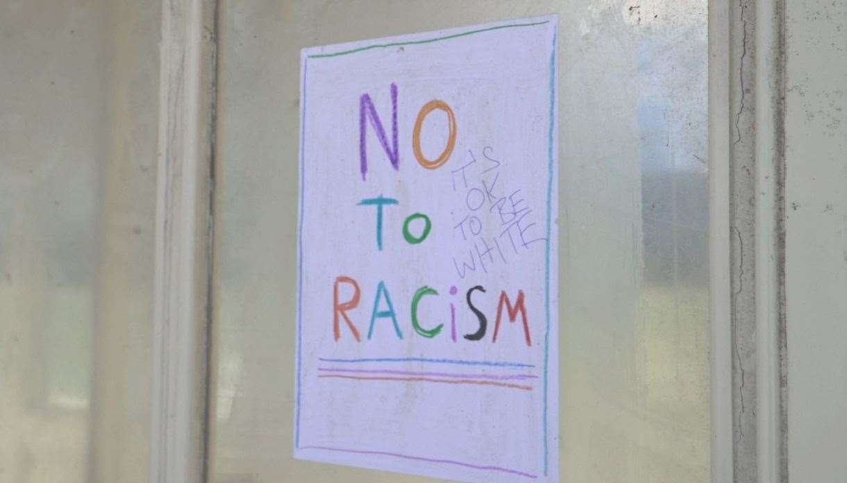 A vandalised anti-racism poster near Herne Bay seafront