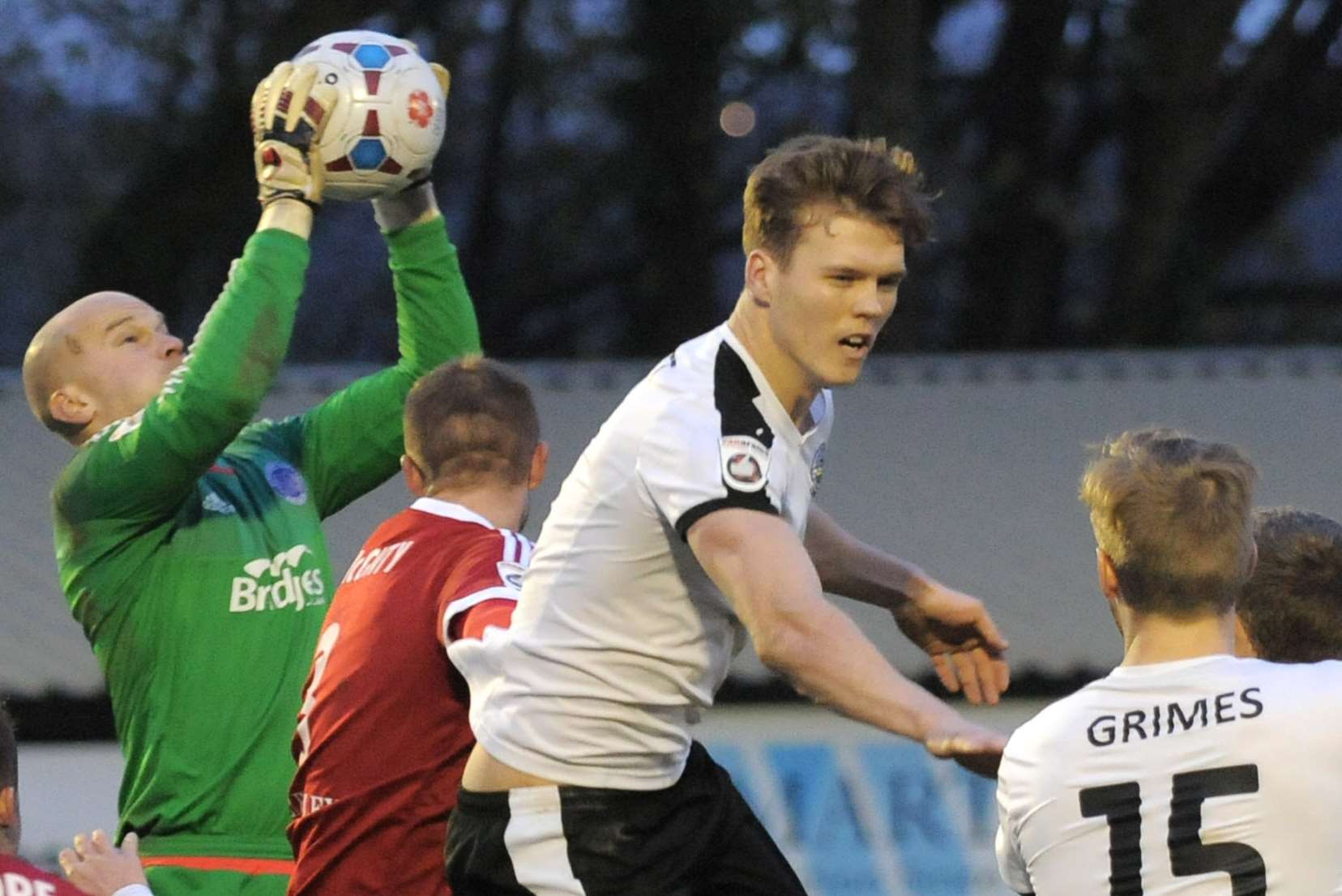 Aldershot keeper Phil Smith catches the ball under pressure from Dover's Sean Raggett Picture: Ruth Cuerden