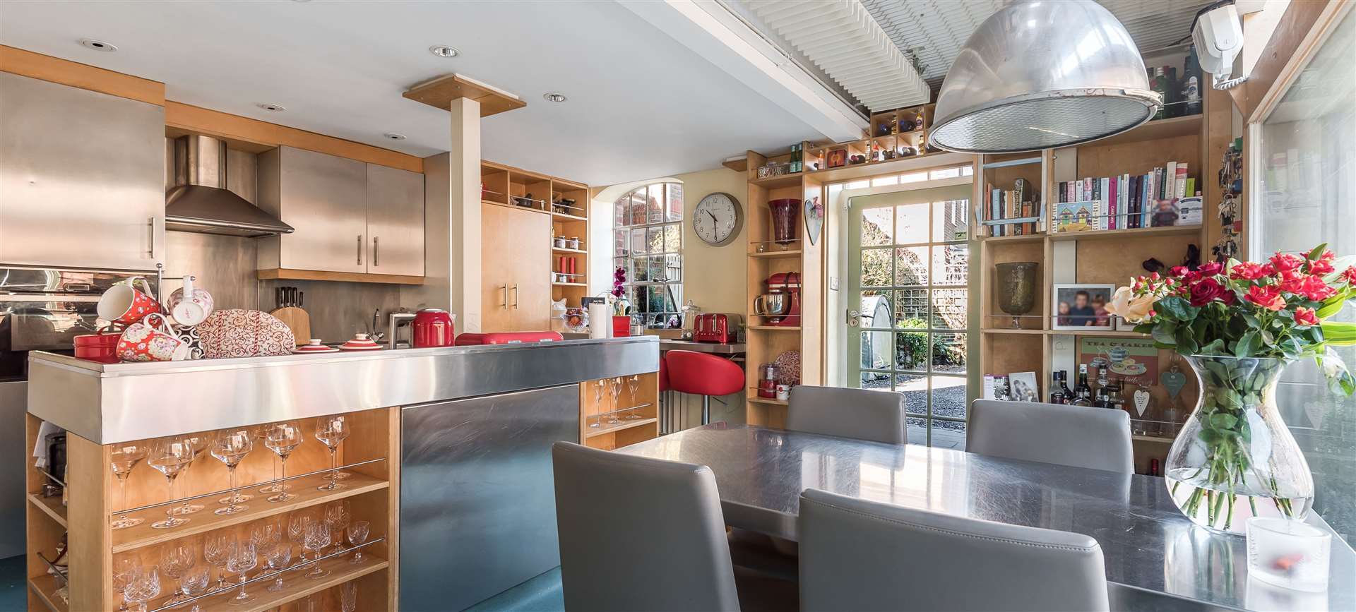 A steel-topped central island and exposed girders in the kitchen