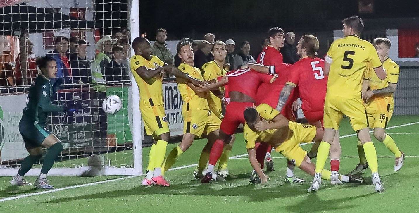 Whitstable defender Finn O'Mara (No.5) heads home the winner past Bearsted keeper Frankie Leonard on Tuesday. Picture: Les Biggs