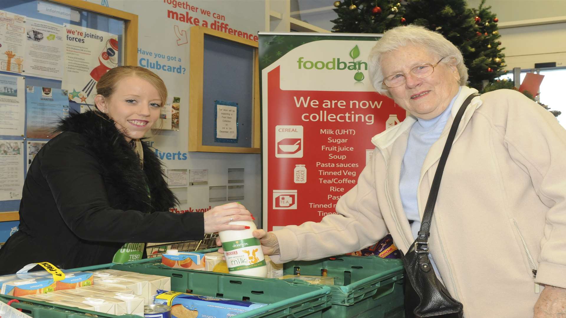 Natasha Blundell takes food from Sheila Flynn.