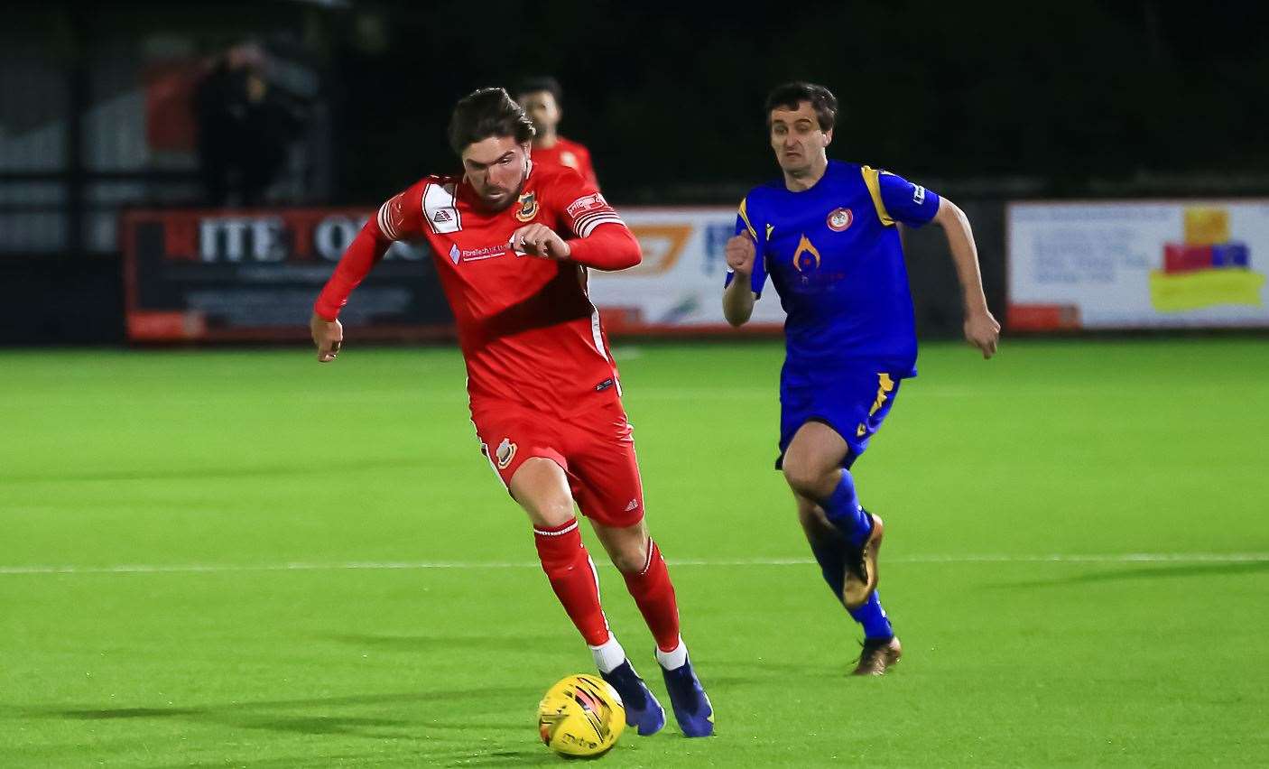 Midweek scorer Matt Gething runs away from Tom Loynes in Whitstable's 2-1 home defeat to Hollands & Blair. Picture: Les Biggs