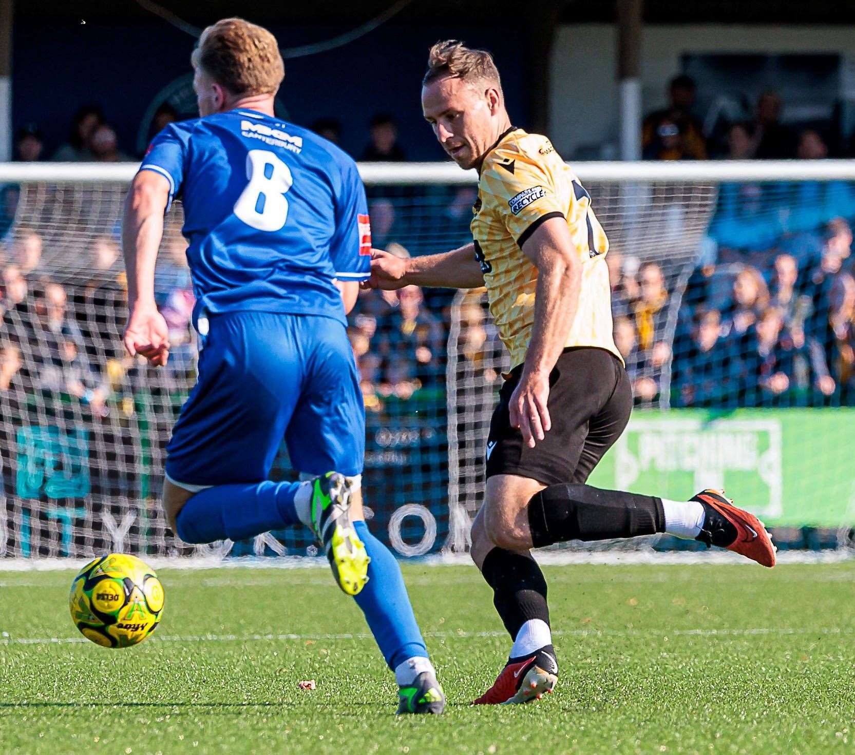 Ethan Smith, of Herne Bay, takes on Maidstone midfielder Jordan Higgs. Picture: Helen Cooper