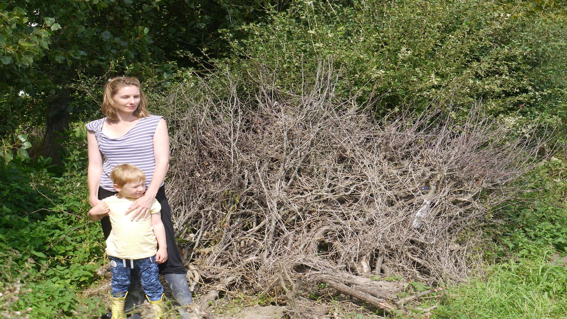 Sally Thomson-Cunningham with her son after two crashes through her garden on the same day