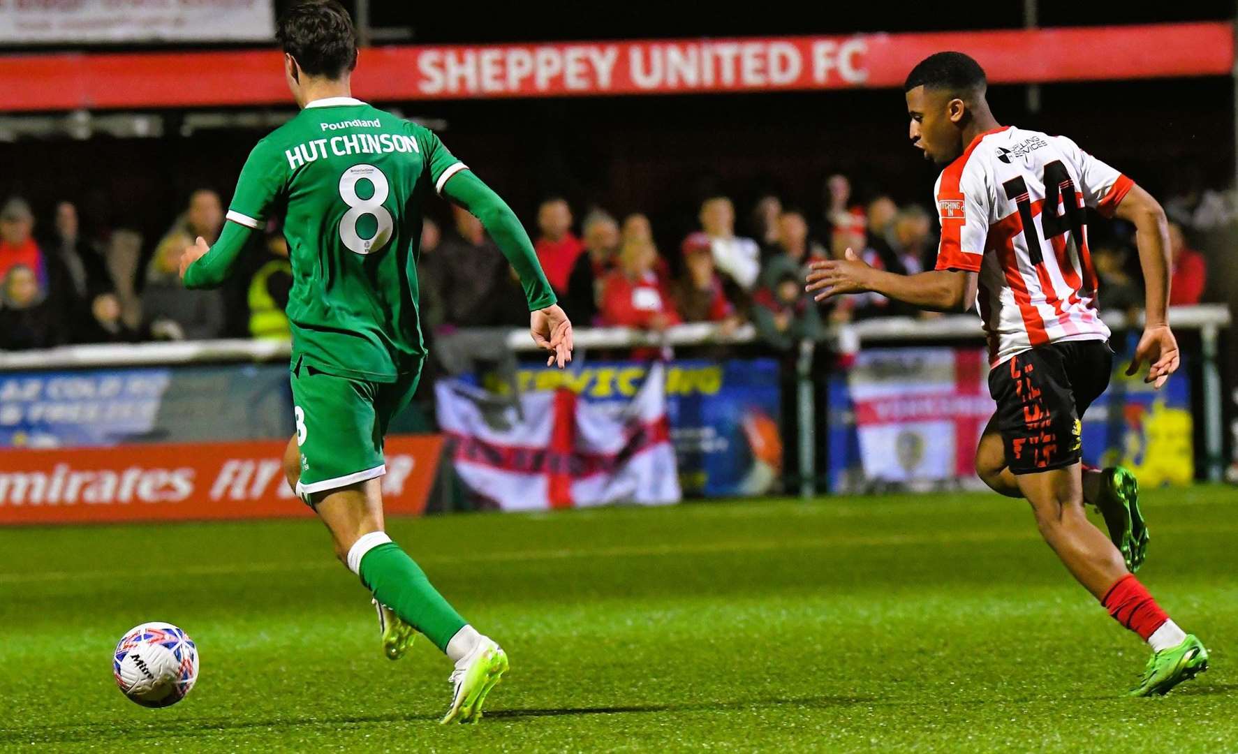 Sheppey defender Mamadou Diallo gives chase to Walsall's Isaac Hutchinson. Picture: Marc Richards