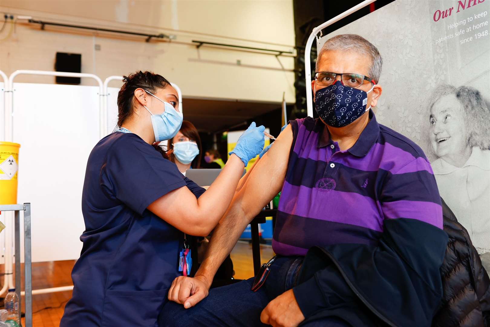 Gina Bii vaccinates a patient at the Gravesend mass vaccine centre at The Woodville