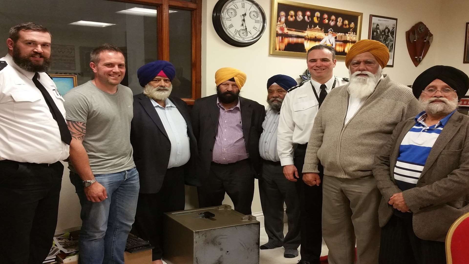 Police hand over the stolen safe to representatives of the Gravesend Gurdwara