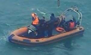 People in a small boat off Dungeness. Credit: Martime and Coastguard Agency