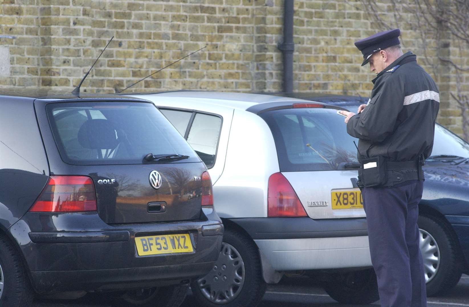 Traffic warden at work. Stock picture