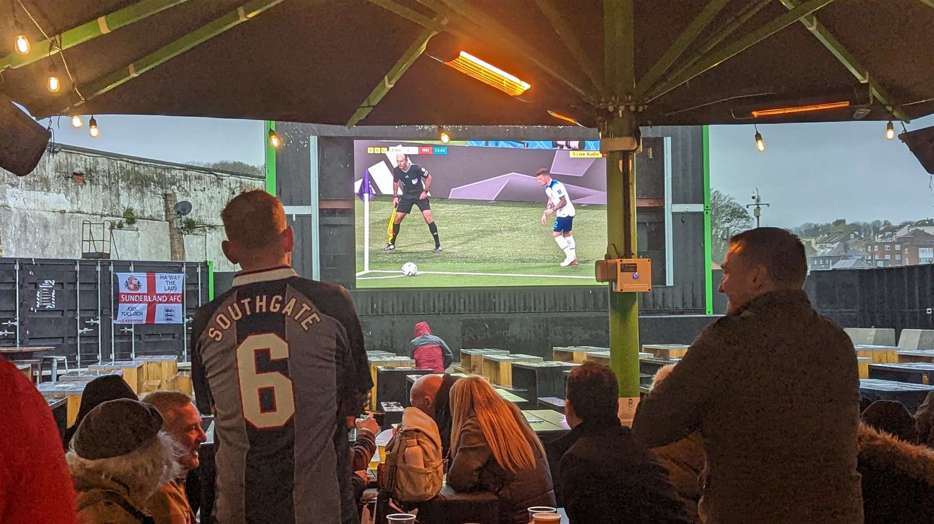 Fans shelter from the elements during the England game