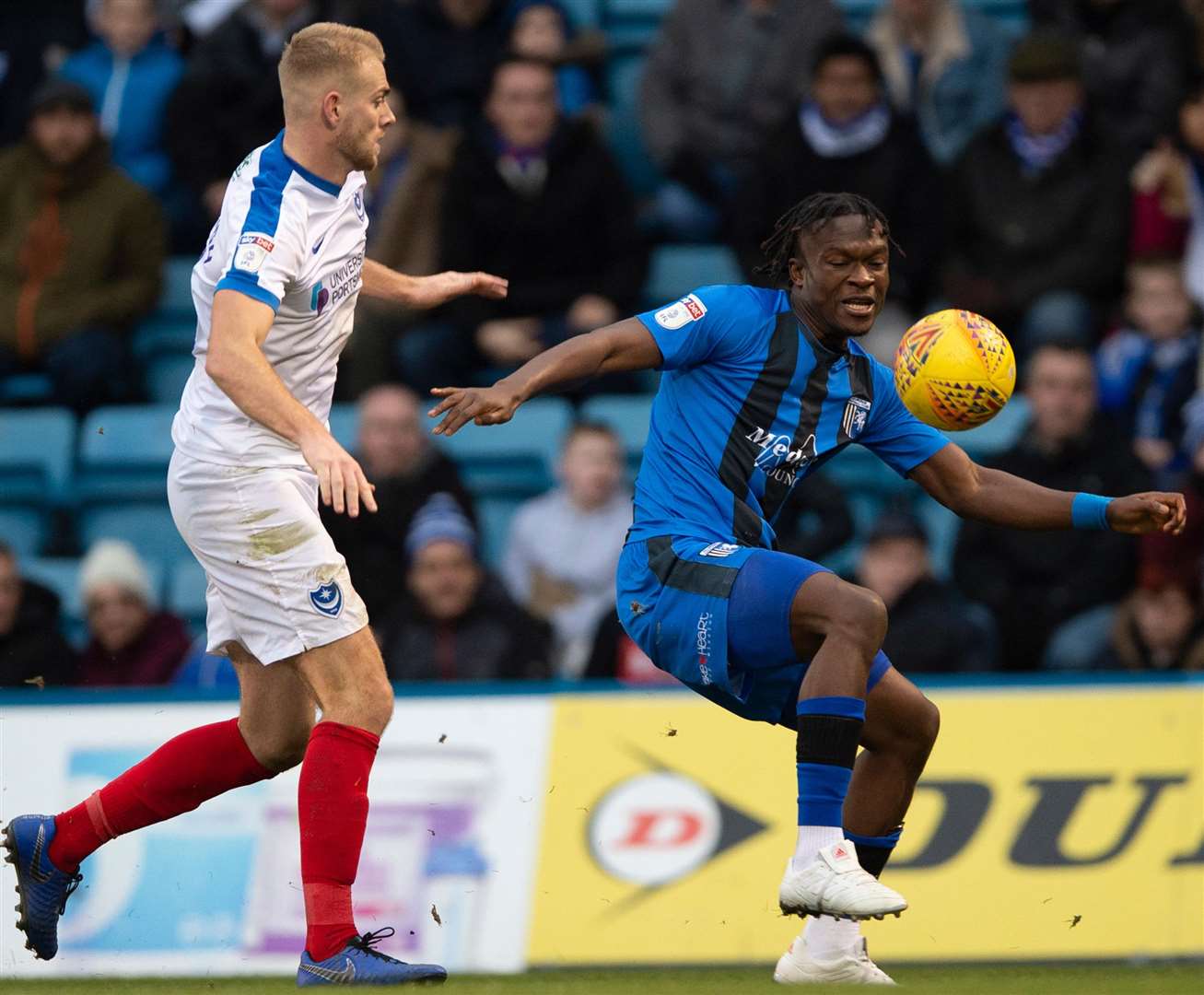 Gillingham debutant Noel Mbo looks to get the ball under control against Jack Whatmough. Picture: Ady Kerry