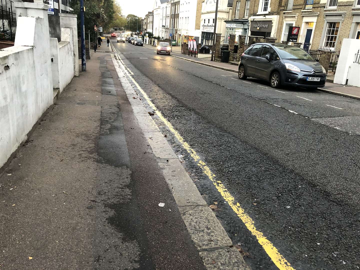 The water is running down the side of the kerb