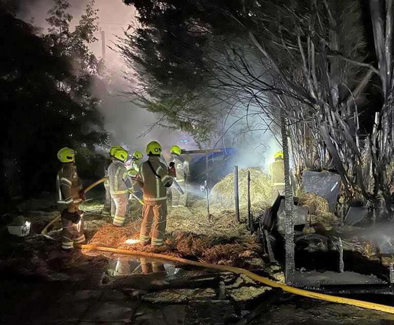 Firefighters worked to extinguish the fire at the stables in Worth