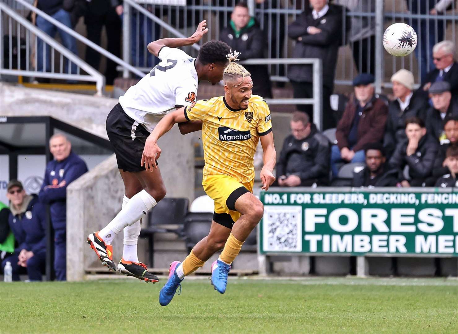 Jordan Wyner wins the ball ahead of Maidstone striker Matt Bentley. Picture: Helen Cooper