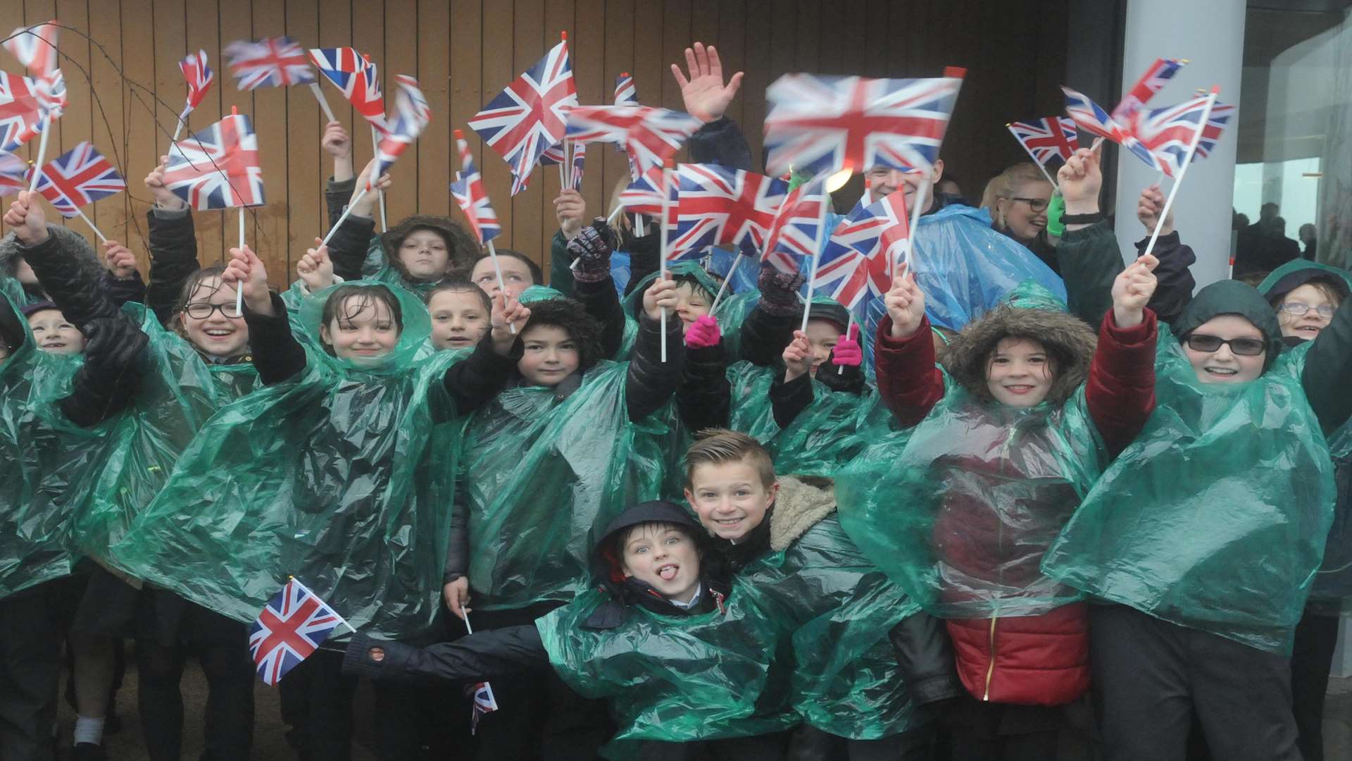 Excited youngsters braved the rain to cheer for the Queen