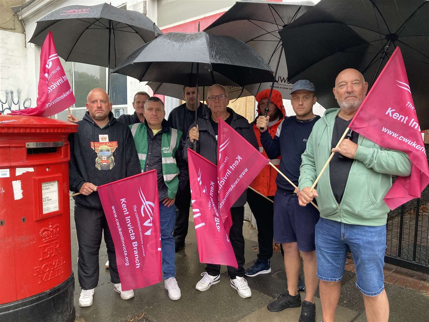 Communication Workers Union pickets striking in the rain outside the Royal Mail's depot in Sheerness Broadway