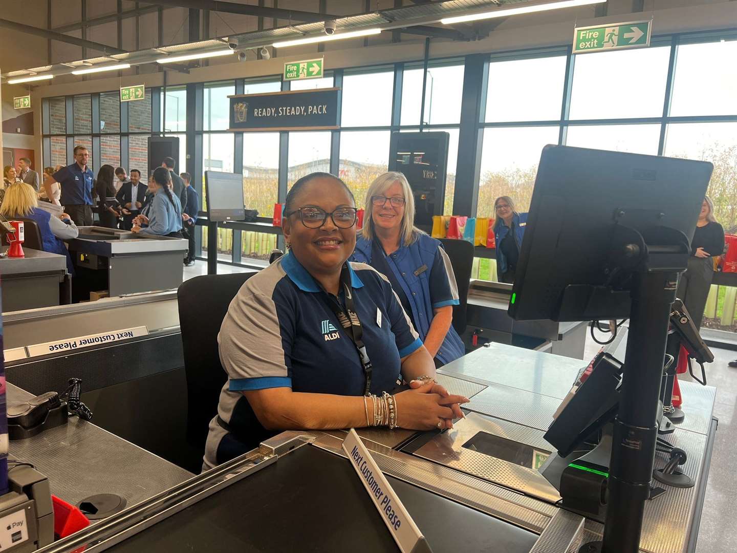 Staff at the checkout at Aldi