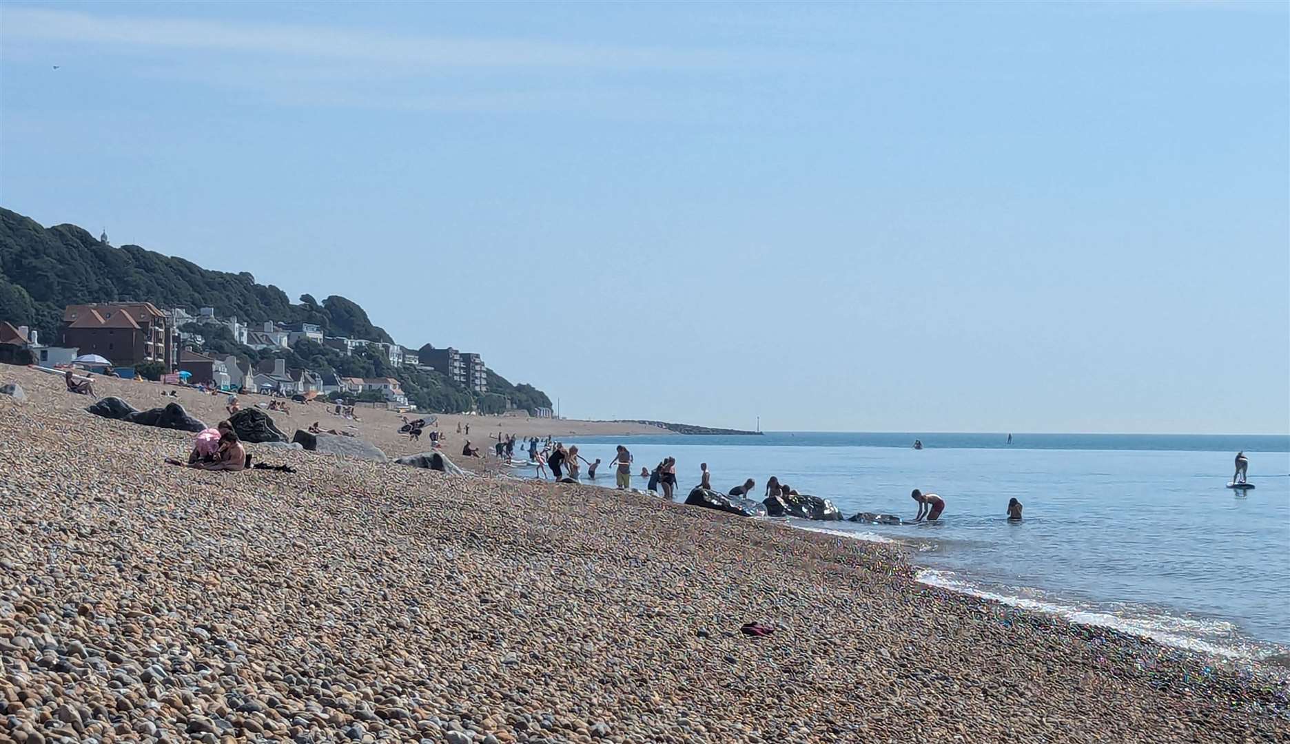 Beach-goers enjoying the warm weather at Sandgate beach