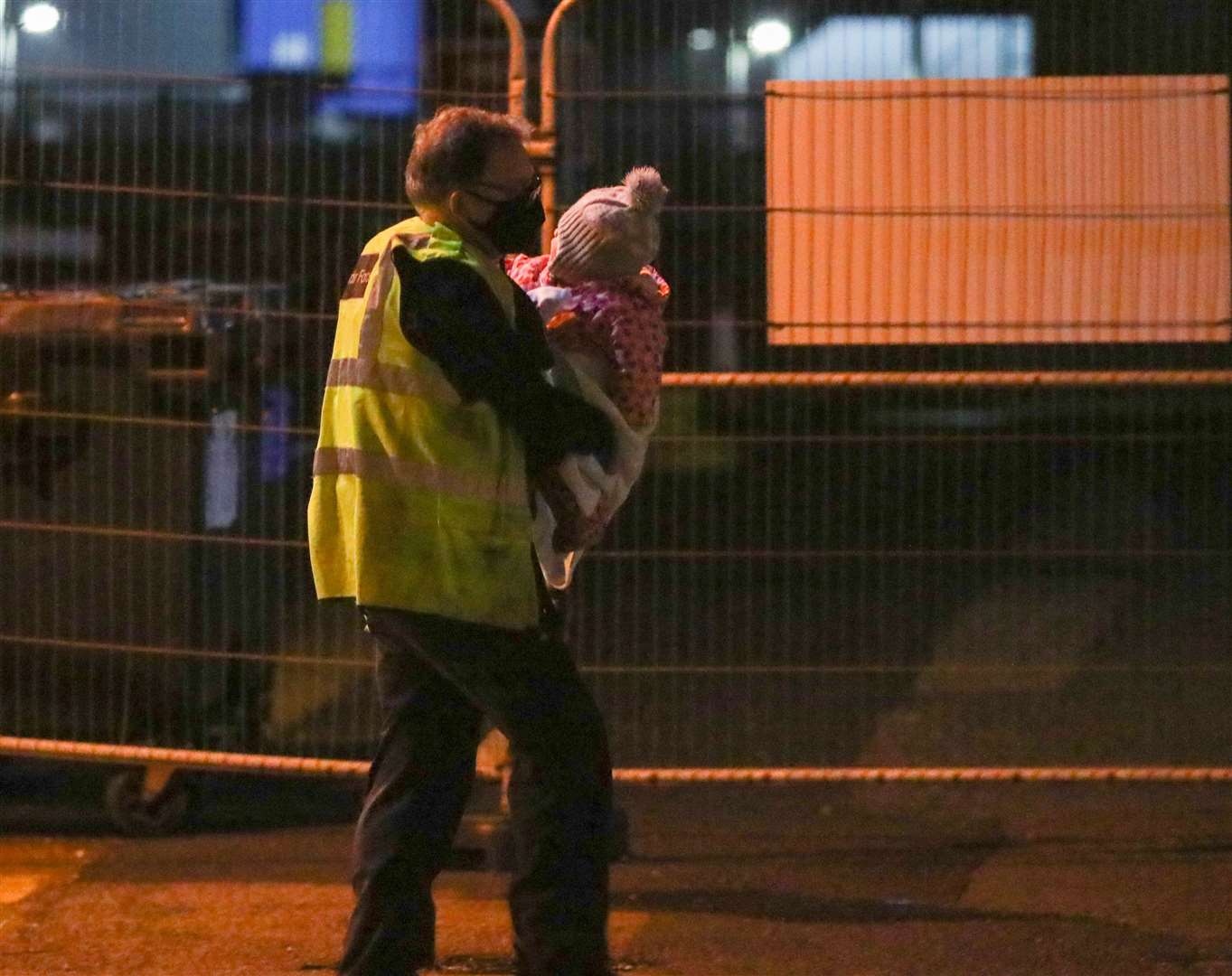 An official carrying one of the children. Picture: UKNIP