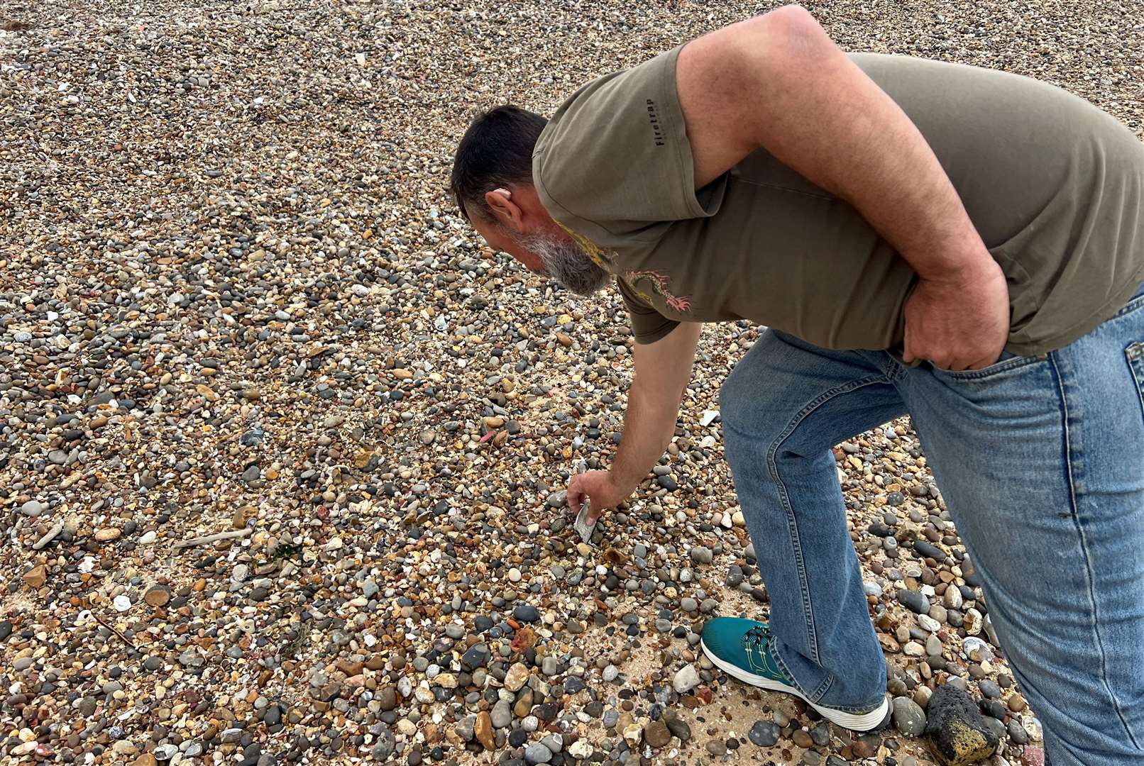 Daniel Hogburn finding asbestos on Minster Beach. Picture: Megan Carr