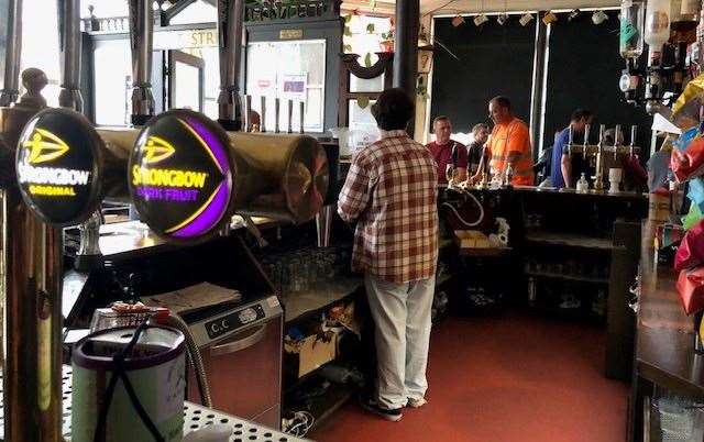 The dark brown wooden bar, which sits centrally in the pub, is surrounded by a whole host of fascinating items