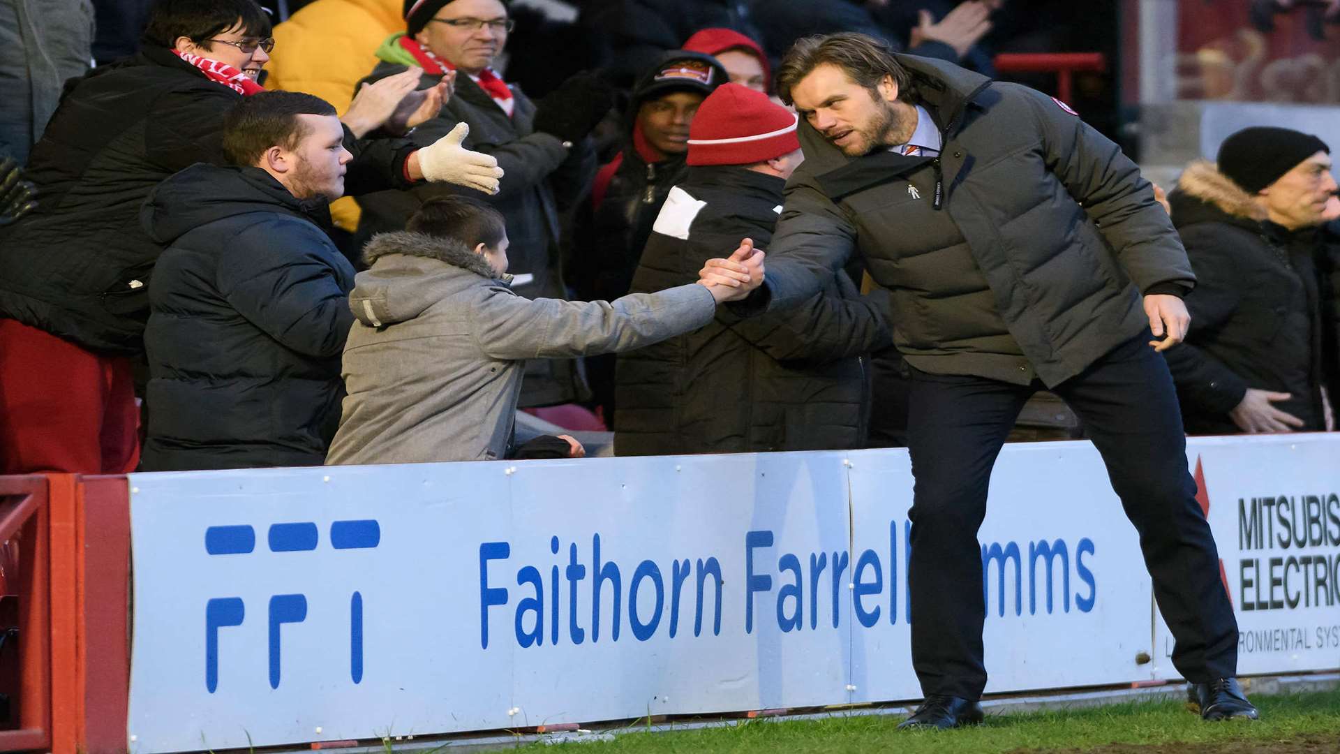 Daryl McMahon celebrates with a young fan at full-time Picture: Andy Payton