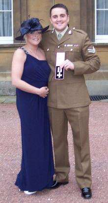 Mark Carpenter with his wife Amy at Buckingham Palace