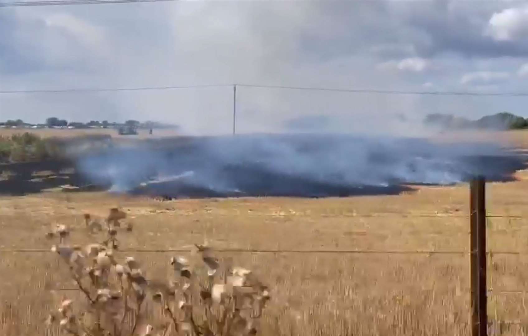 The fire and scorched field as seen from the Romney Hythe & Dymchurch Railway. Picture: Les Jeal