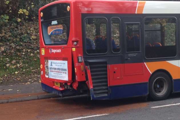 The damage to the bus after a collision between it and a car