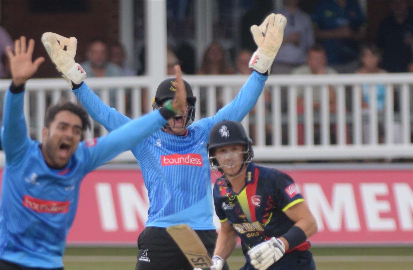 Joe Denly's survives the appeal of Sussex keeper Burgess and bowler Rashid Khan. Picture: Chris Davey.