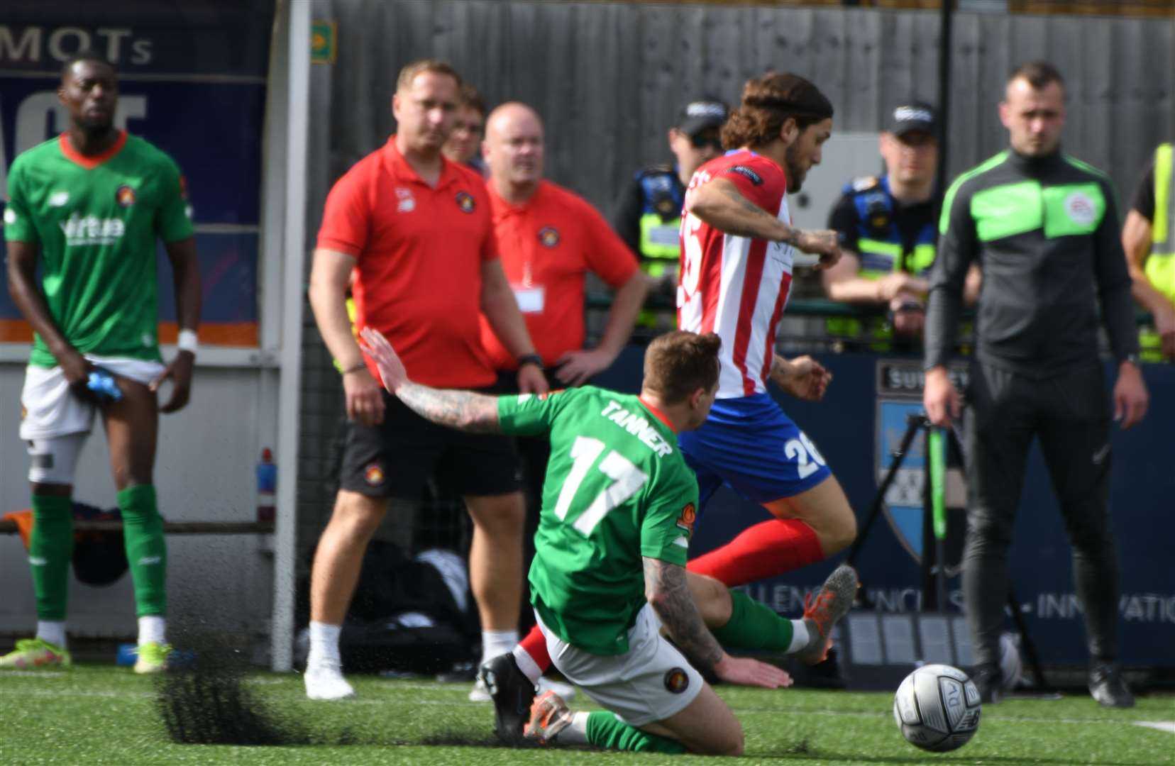 Fleet's Craig Tanner slides in against Dorking's former Gills midfielder Darren Oldaker. Picture: Barry Goodwin