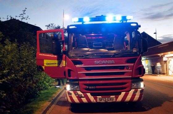 Fire fighters put out a blaze in Sittingbourne High Street. Stock photo.