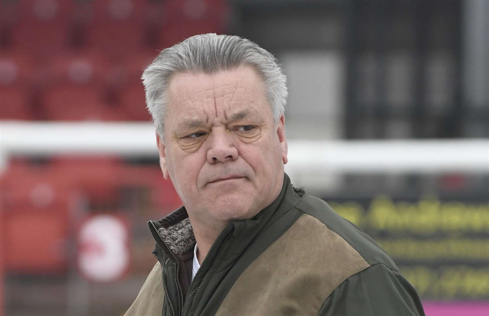 Dover chairman Jim Parmenter lends a hand as snow is cleared from the pitch in 2018 - he says times have changed since then. Picture: Tony Flashman