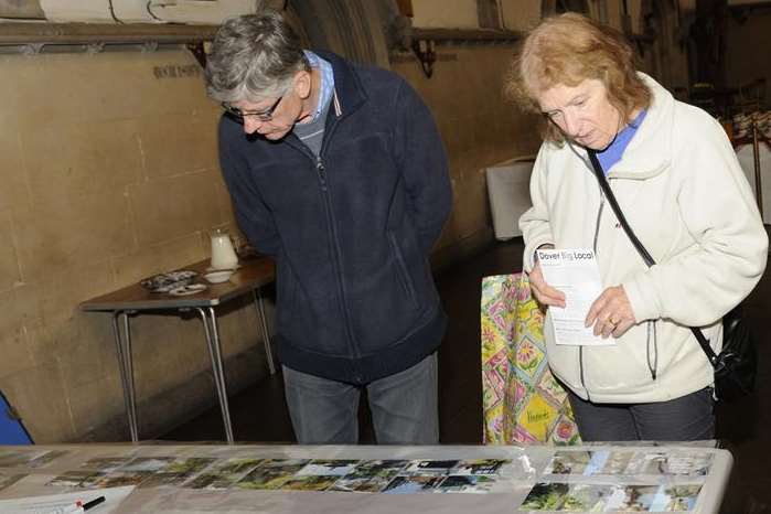 Len and Bernadette Stevens study photographs at the BigLocal project.