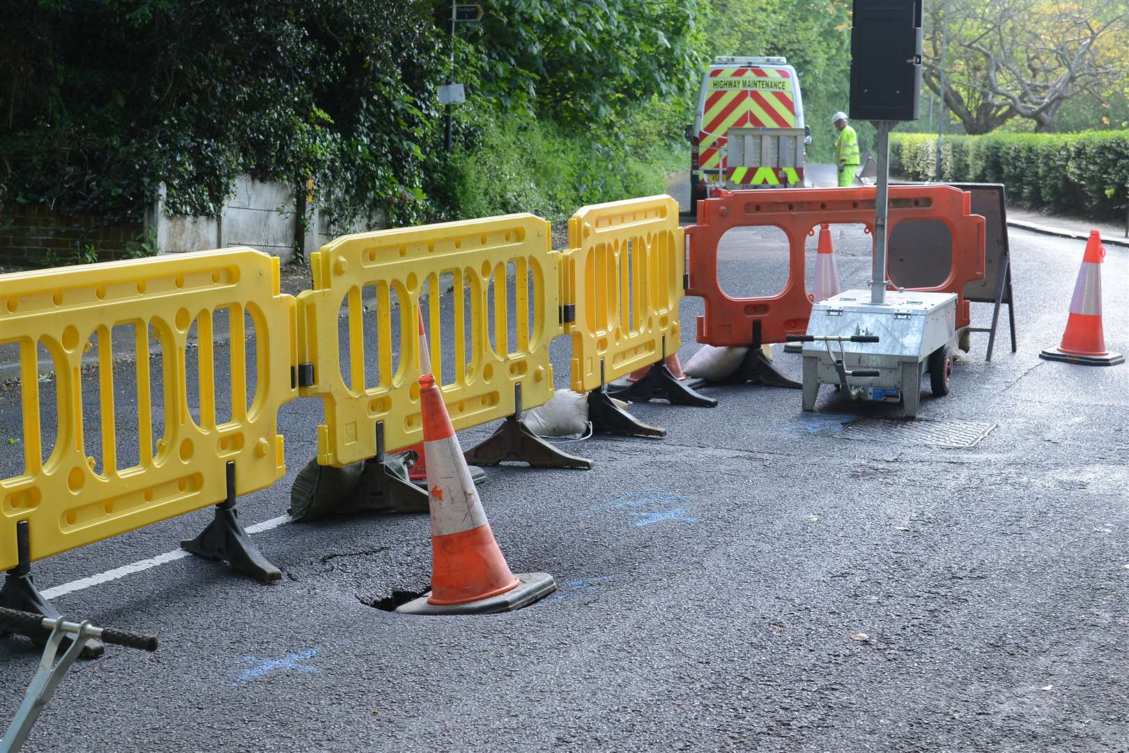 The road is not a sinkhole but caused by a burst water pipe washing earth away under the road surface. Picture: Gary Browne