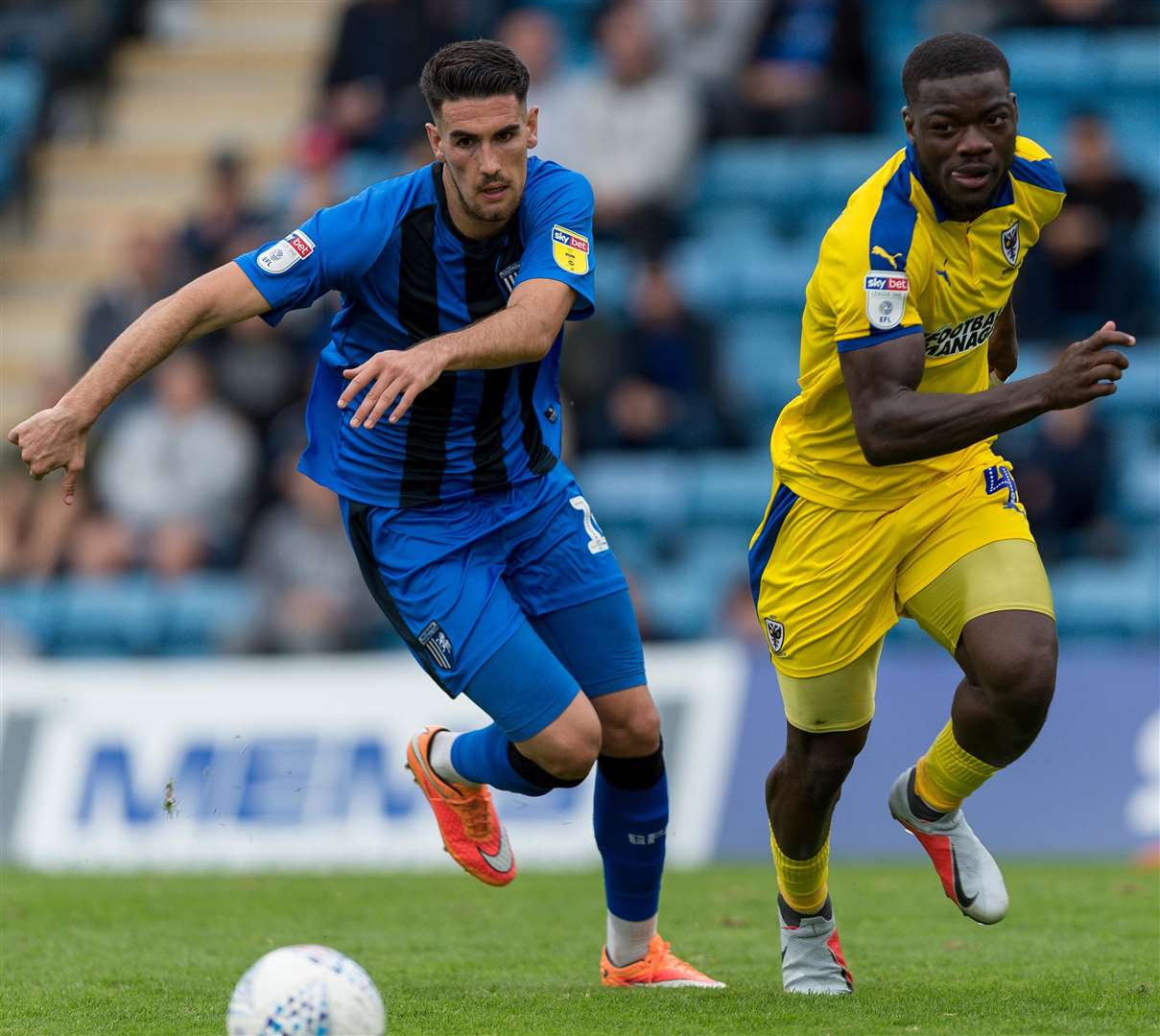 Conor Wilkinson in a foot race with ex-Gill Deji Oshilaja for the loose ball Picture: Ady Kerry