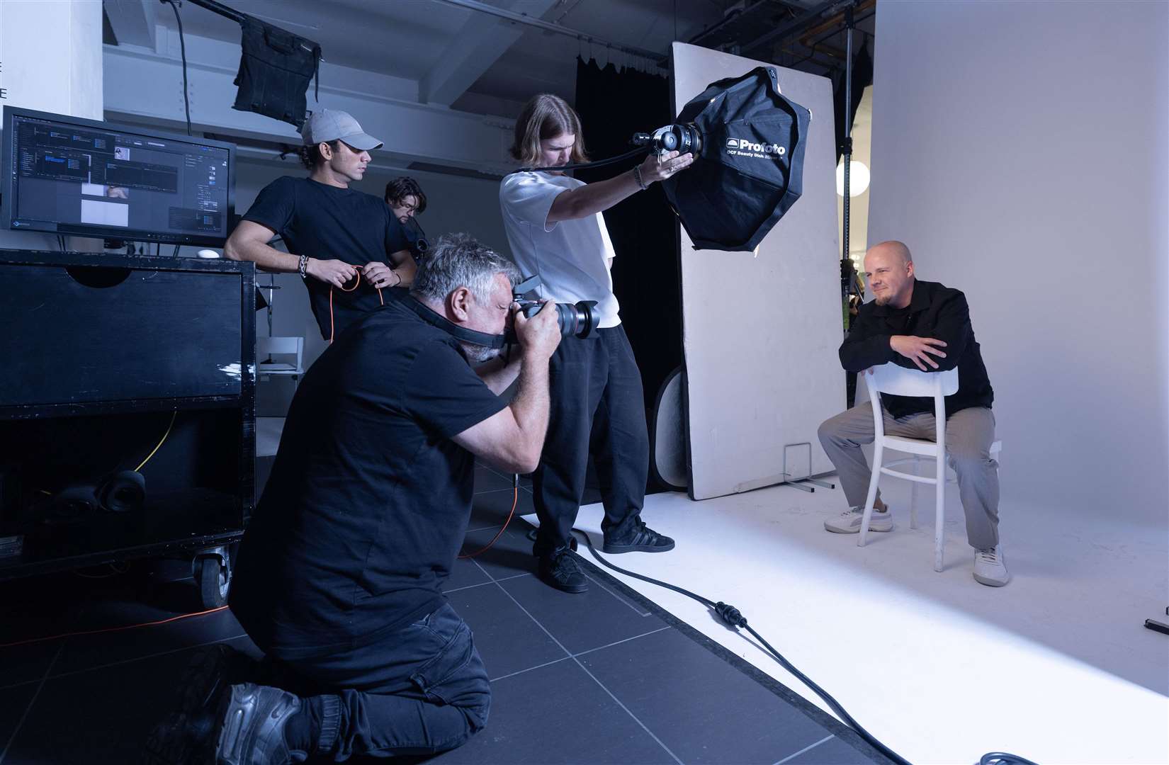 Rankin takes a picture of Matt Evans, aged 44, from Barry in Wales, who is one of 30 millionaires selected to have their portrait taken by Rankin (Matt Alexander/PA)