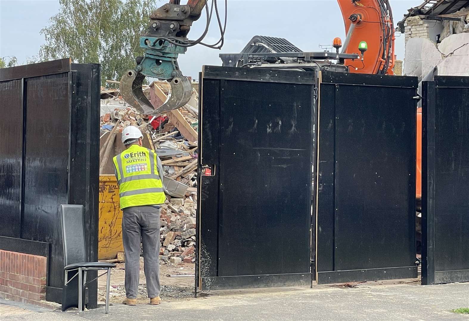 A large black hoarding has been erected around the homes