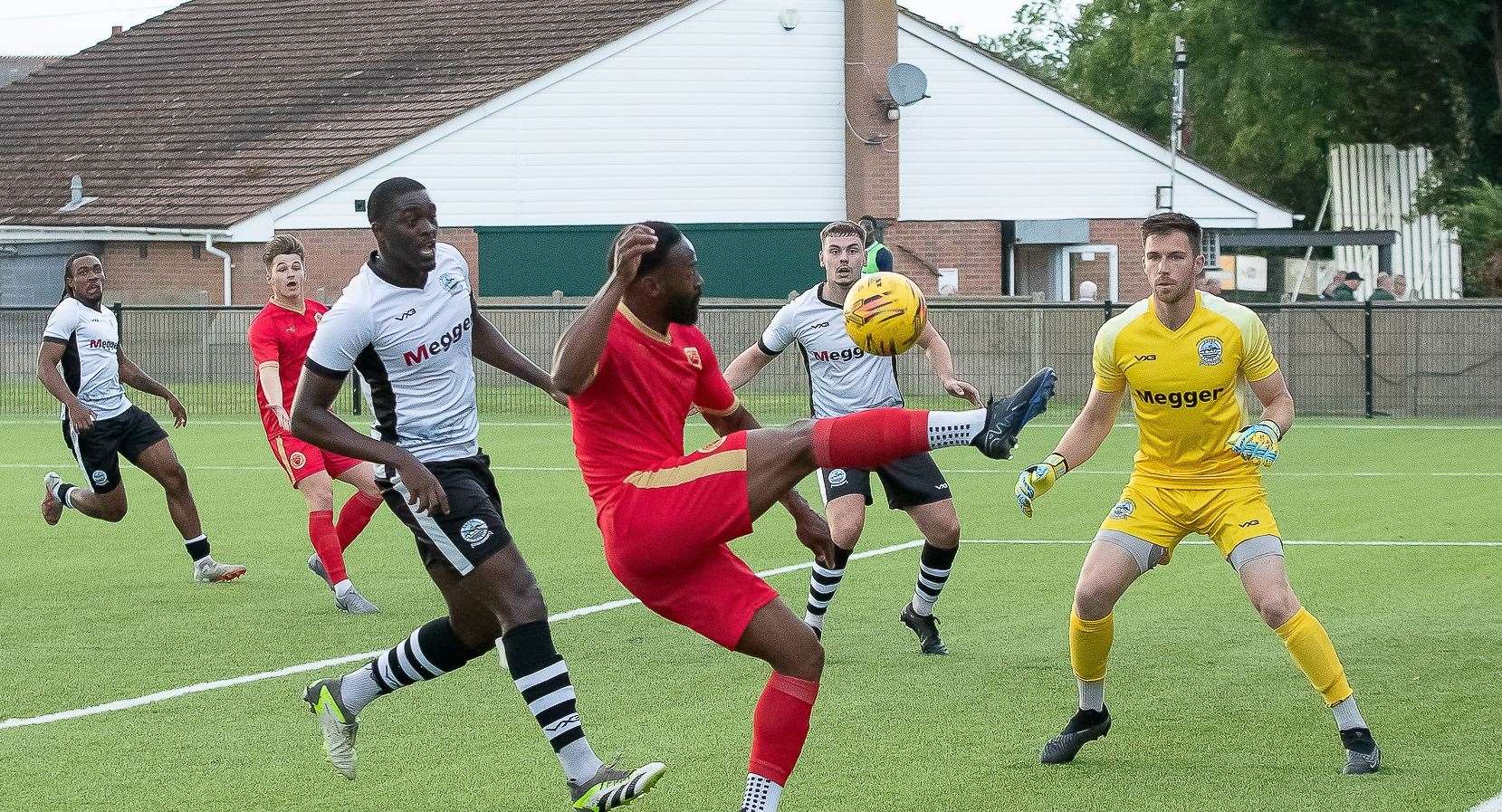 Jerson Dos Santos crosses for Whitstable as Dover goalkeeper Mitch Walker remains on alert. Picture: Les Biggs