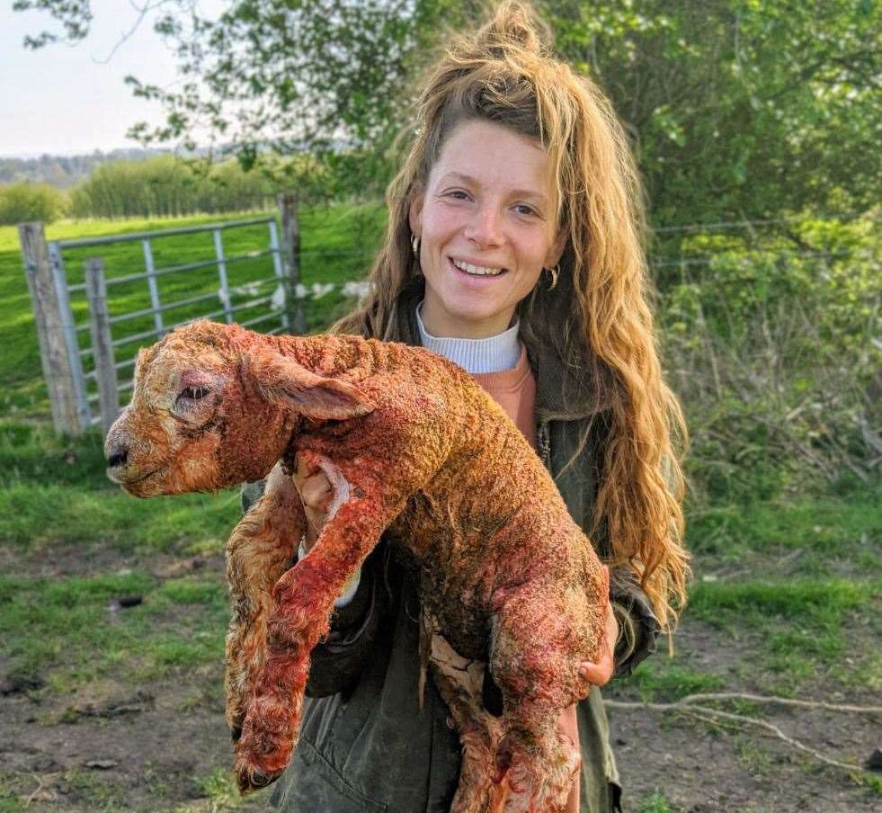 Zoe Colville with a lamb born only minutes before this photo was taken Picture: Zoe Colville