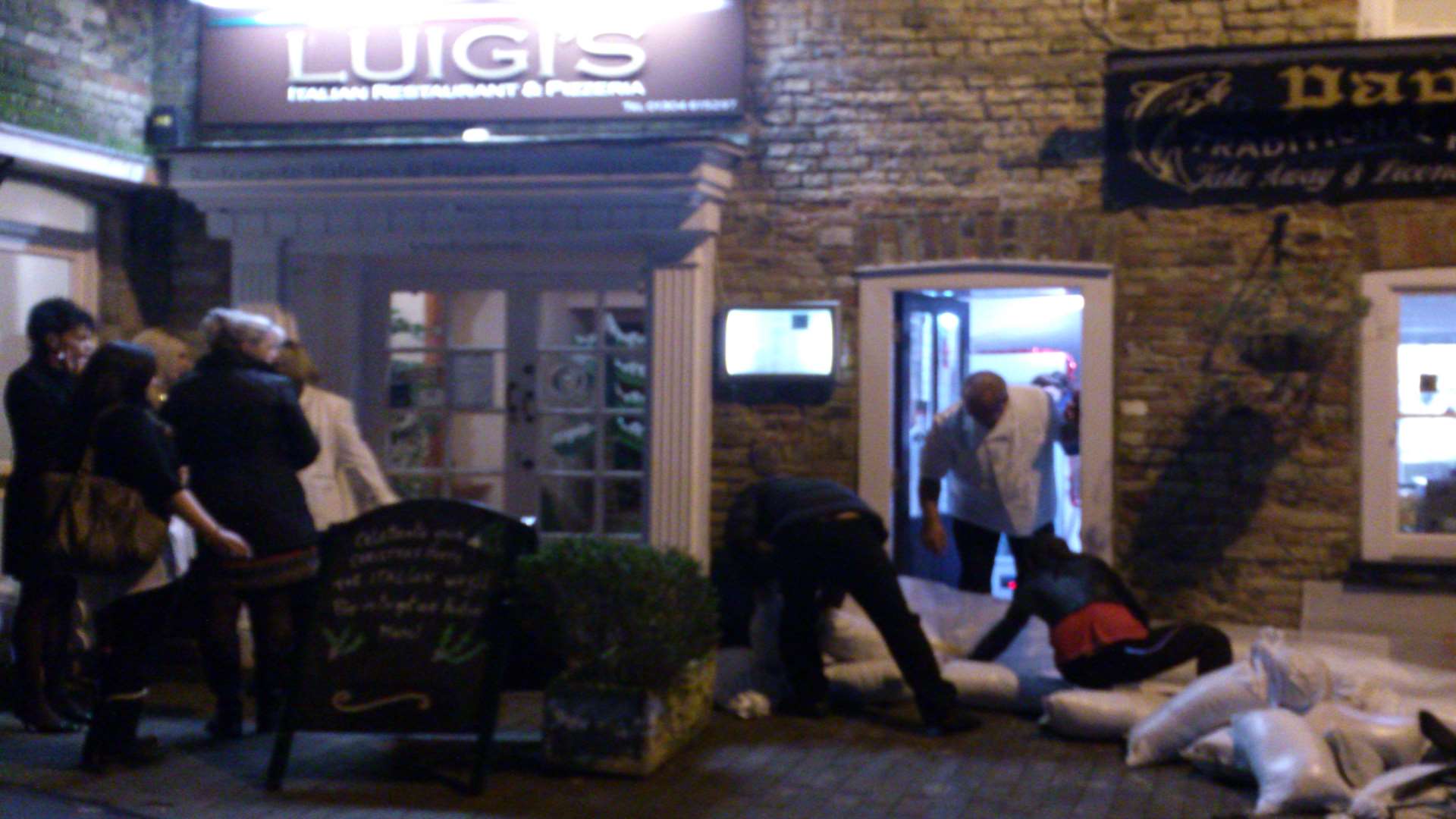 People rush to protect their home and businesses from the tidal surge in Sandwich