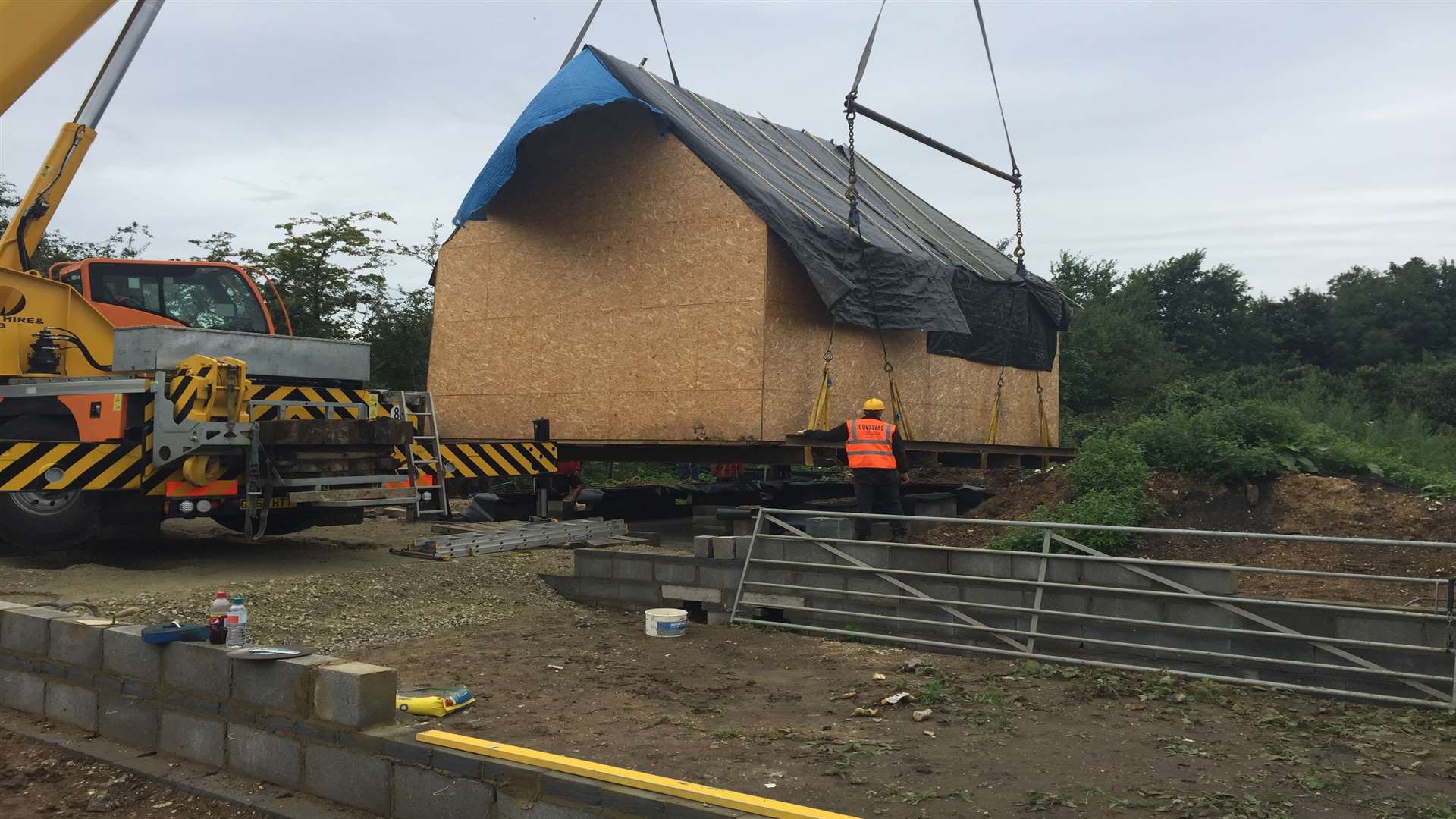 The Black House is lifted by crane to its new site