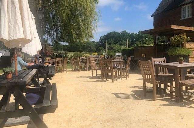 There were plenty of tables and chairs available in the garden, but one woman had secured a spot to do a little work