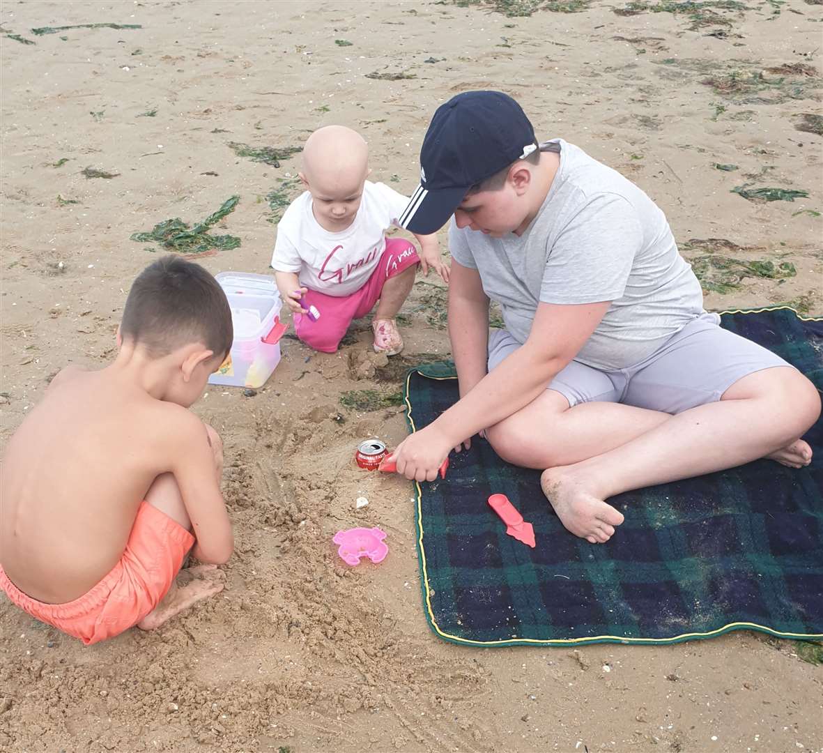 Grace with her brothers Henry, 12, right, and George, five