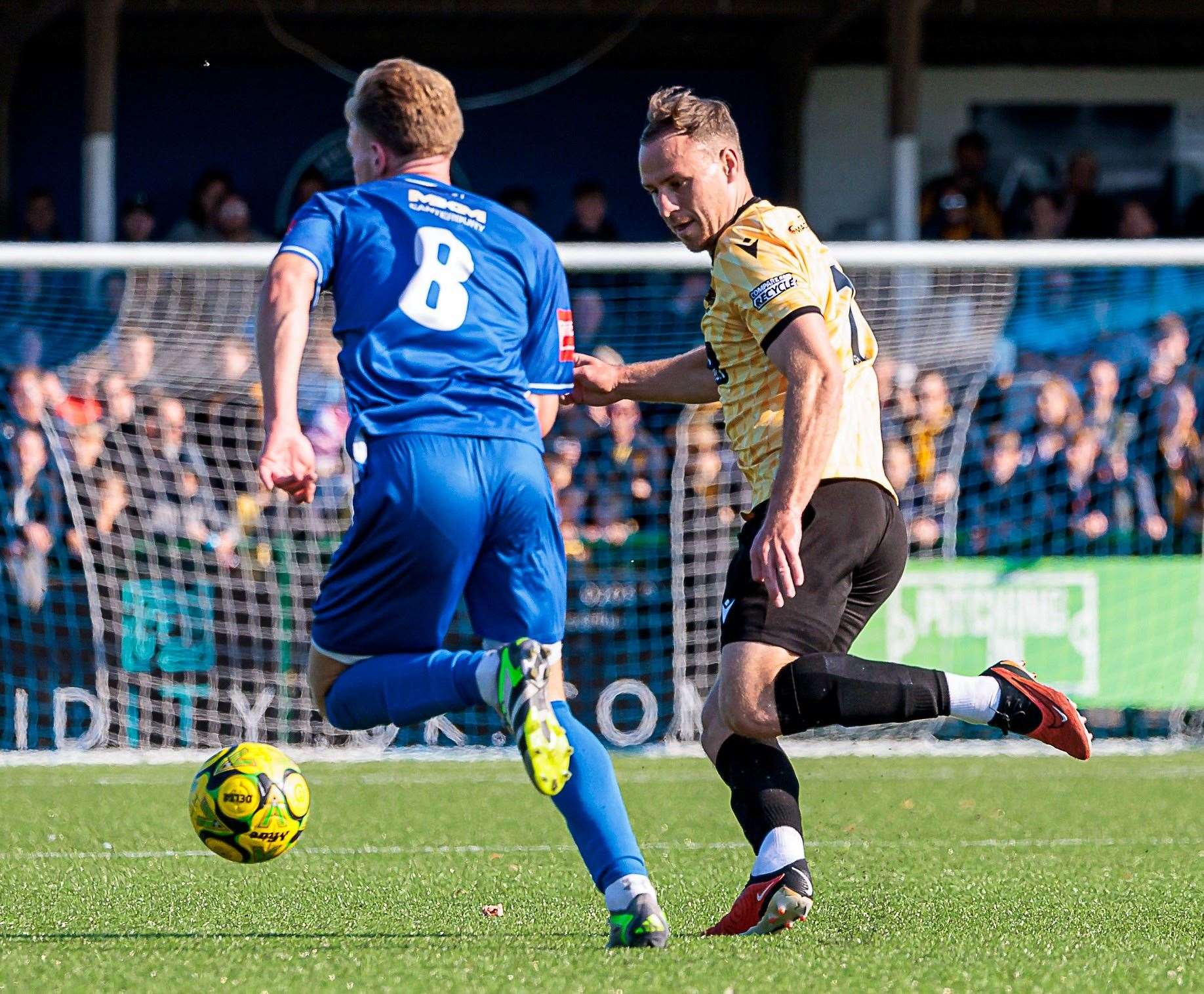 Ethan Smith, of Herne Bay, takes on Maidstone midfielder Jordan Higgs. Picture: Helen Cooper