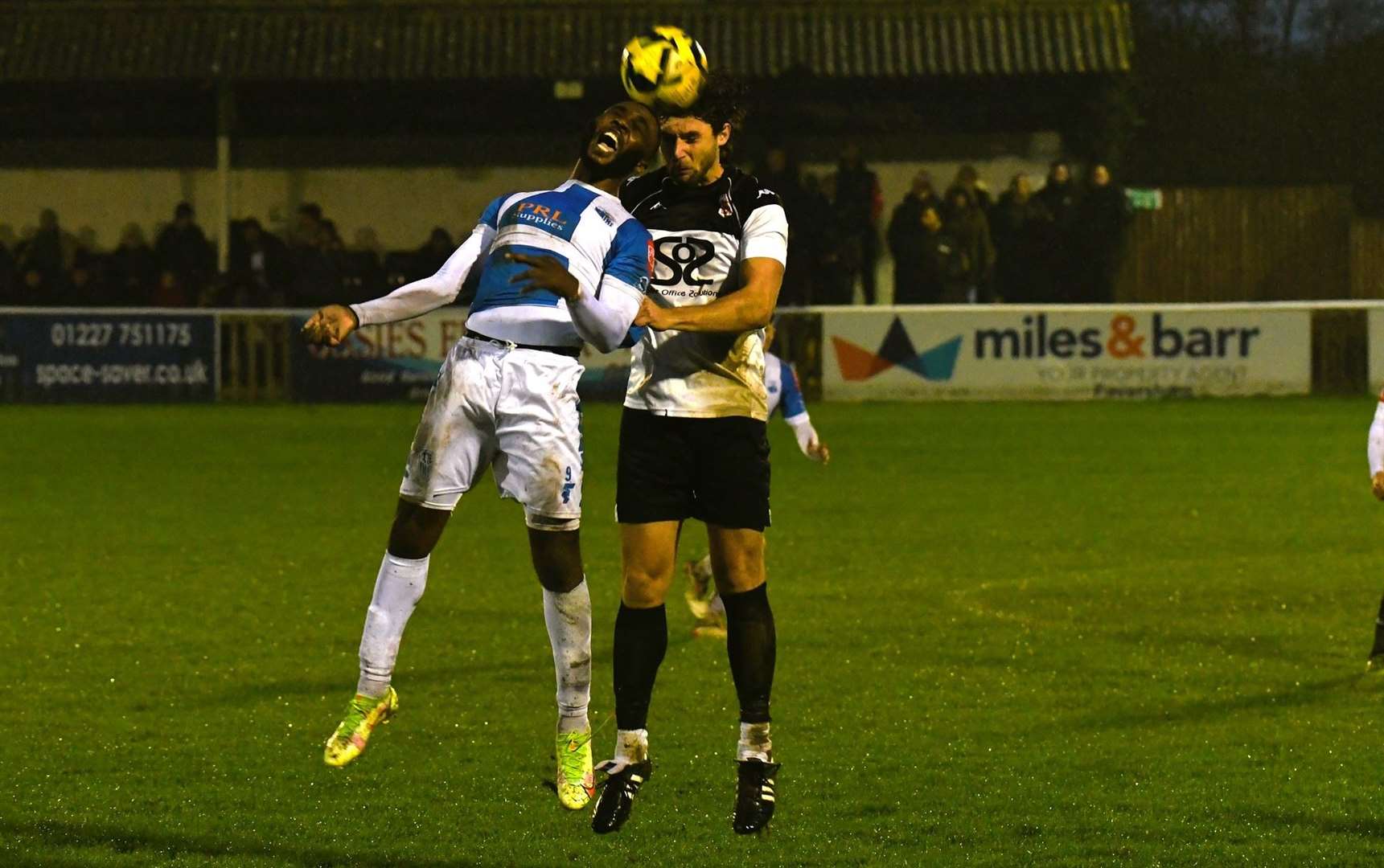 Faversham substitute Ollie Gray wins a header against Sheppey striker Warren Mfula in Town's weekend 3-2 loss. Picture: Marc Richards