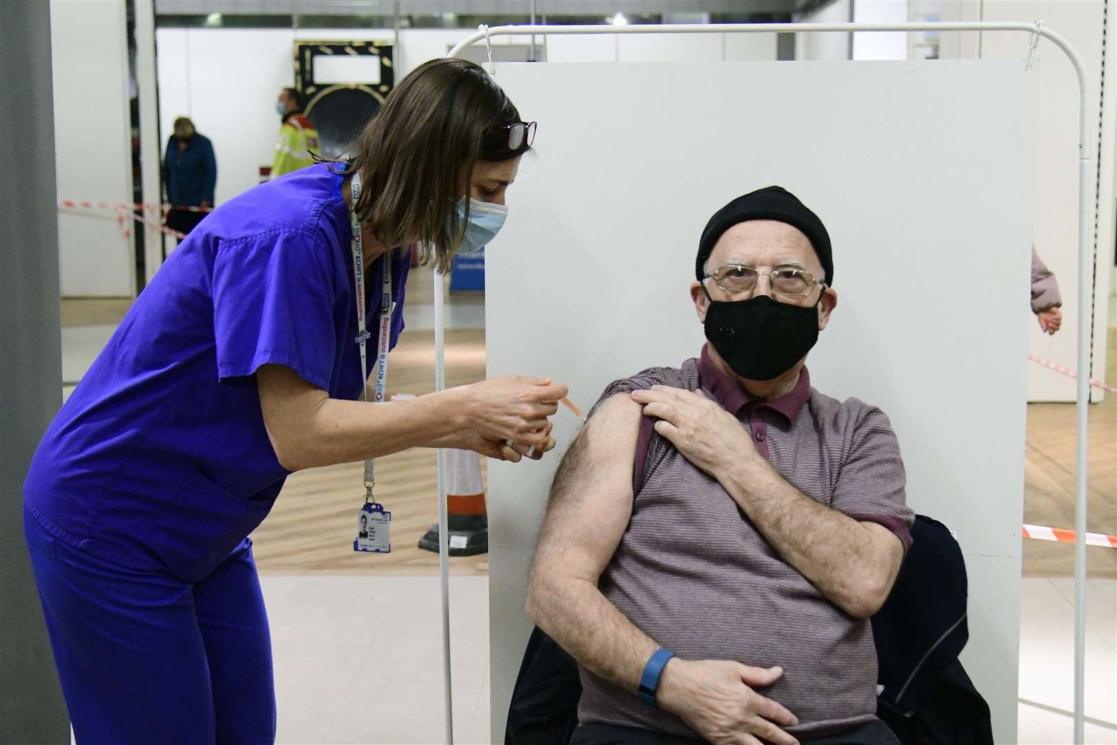 Another person receives the jab at Kent's first mass vaccination centre in the former Debenhams store in Folkestone.